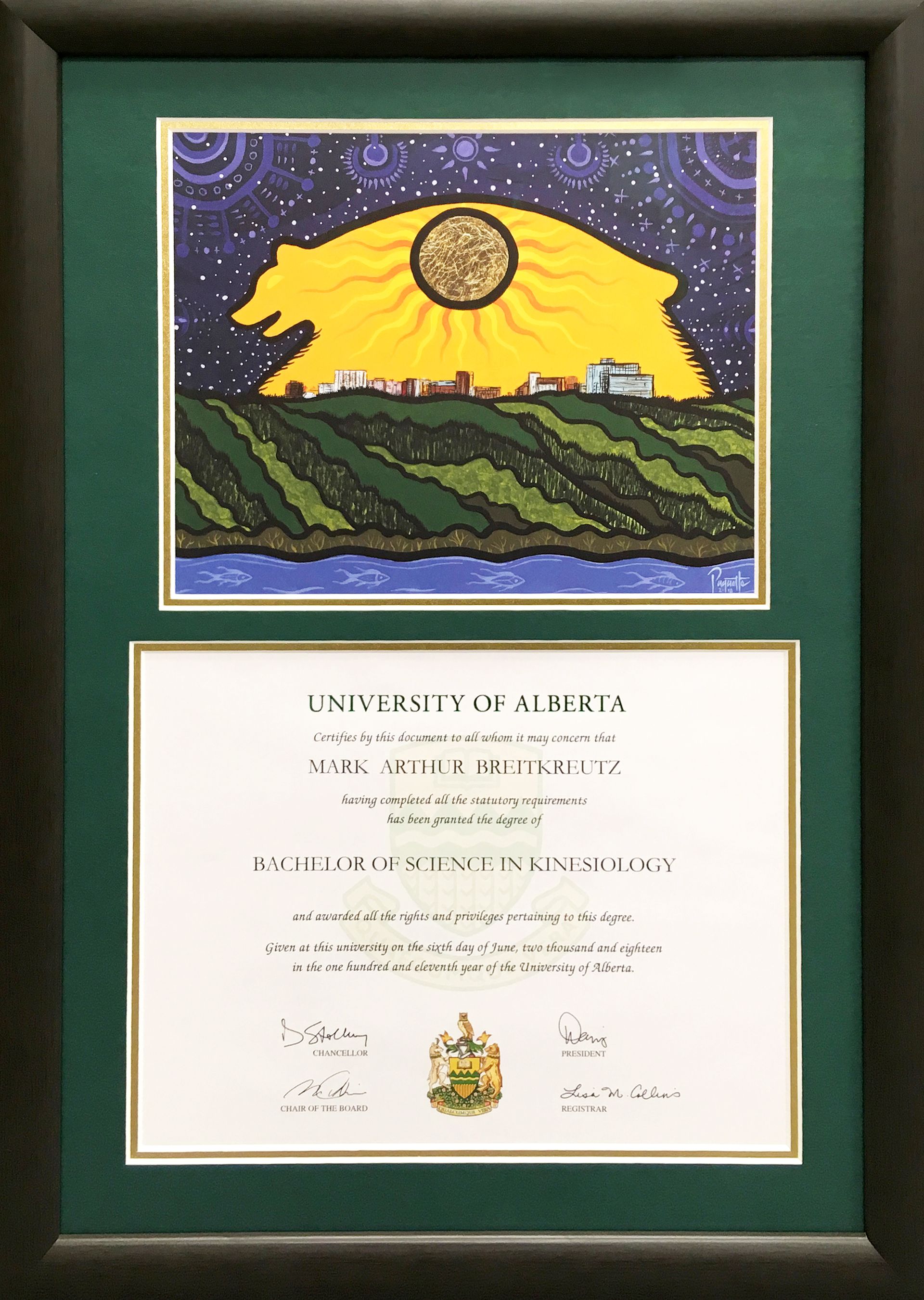 A framed certificate with a picture of a sun on top