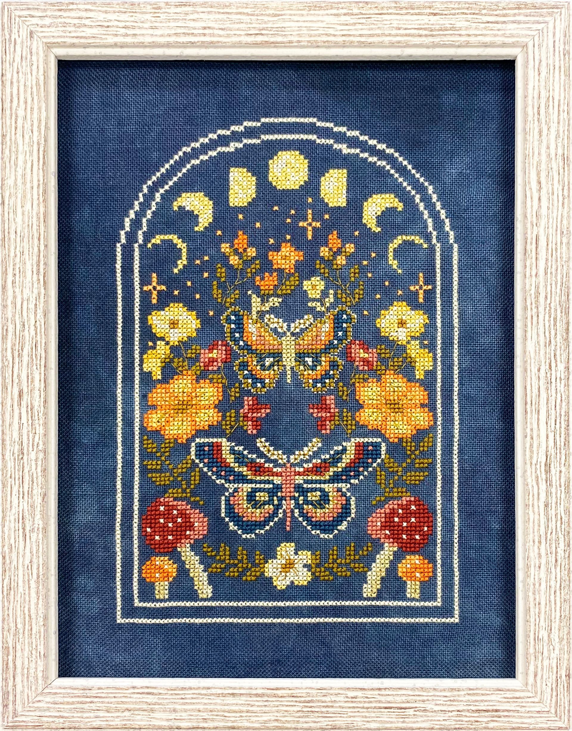Needlecraft framed photo with moons and flowers