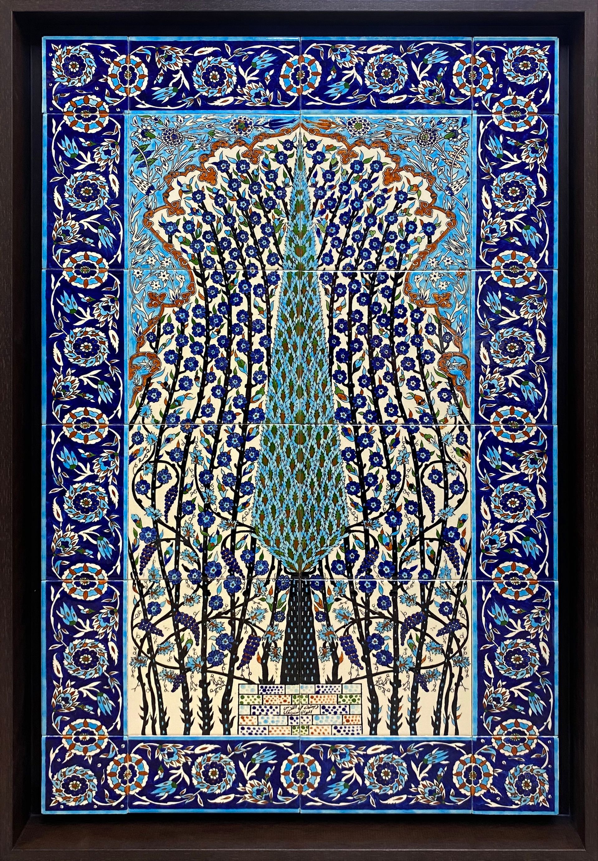 Intricate blue and green peacock needlework design with decorative patterns displayed in a dark frame.