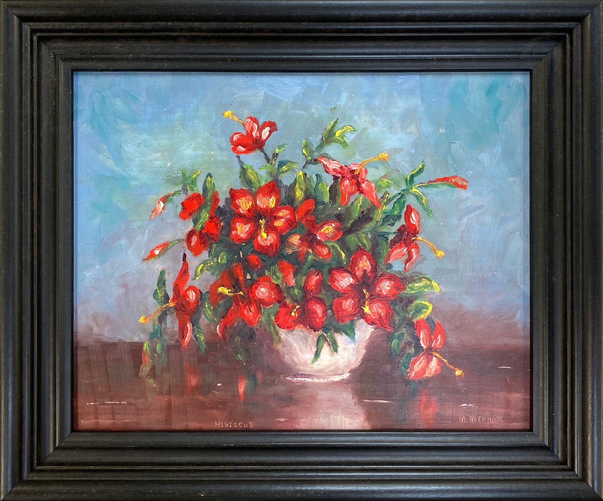 Framed painting of a vase of red flowers with green leaves on a blue and brown background