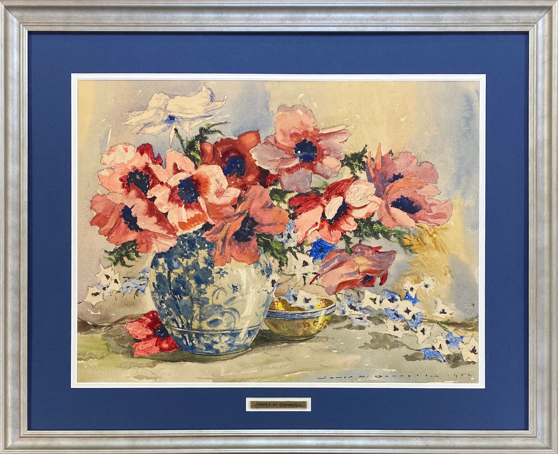 Colourful floral artwork with blue matting in a silver custom frame