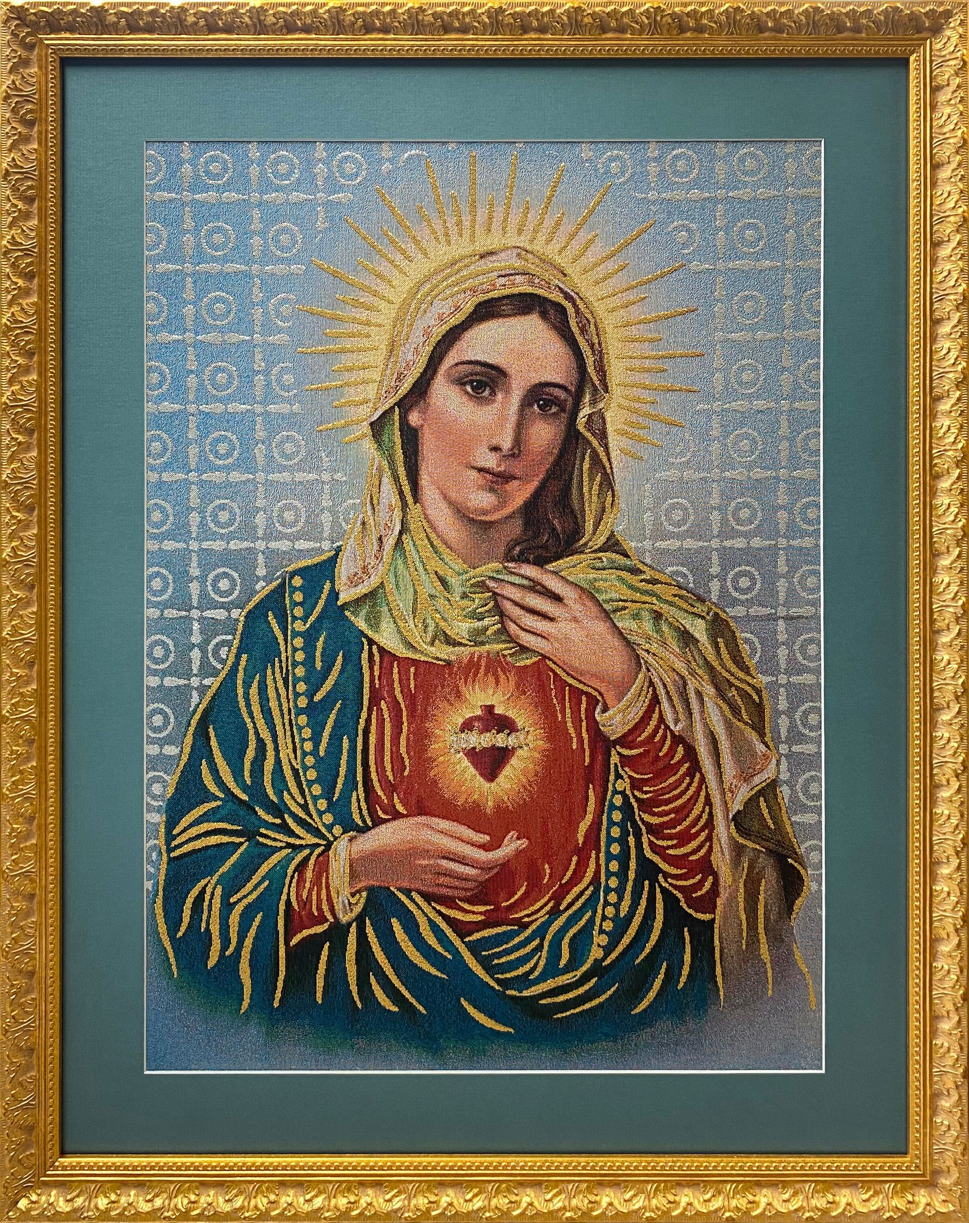 Framed religious needlework portrait of the Virgin Mary with a golden halo and decorative gold frame.