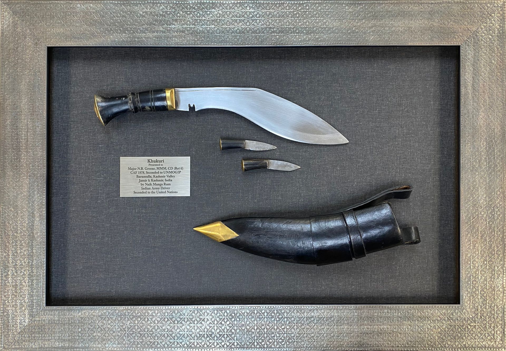 an antique knife in a shadow box