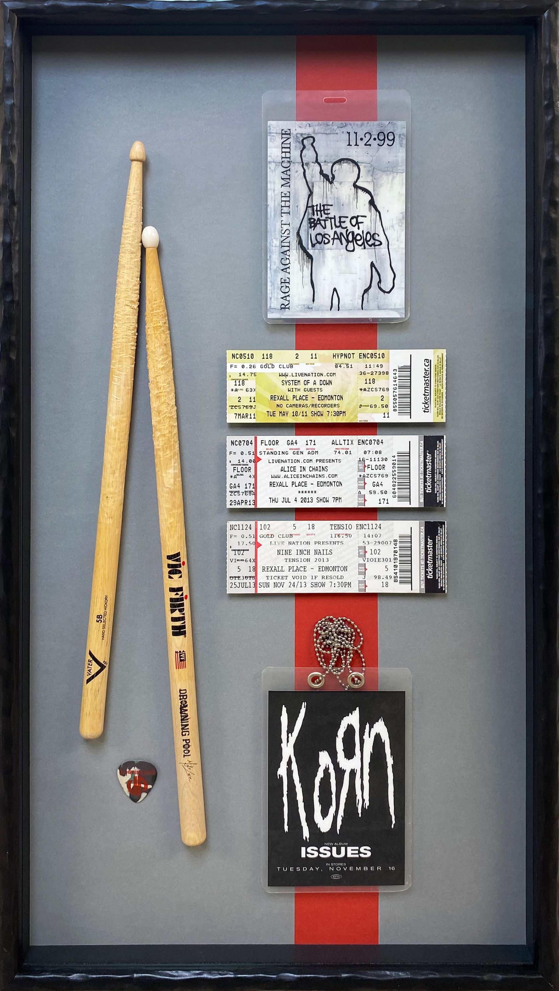 Signed drumsticks by Korn in a shadow box