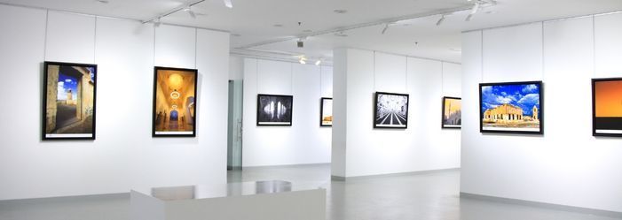 A large room with a lot of pictures hanging on the walls.