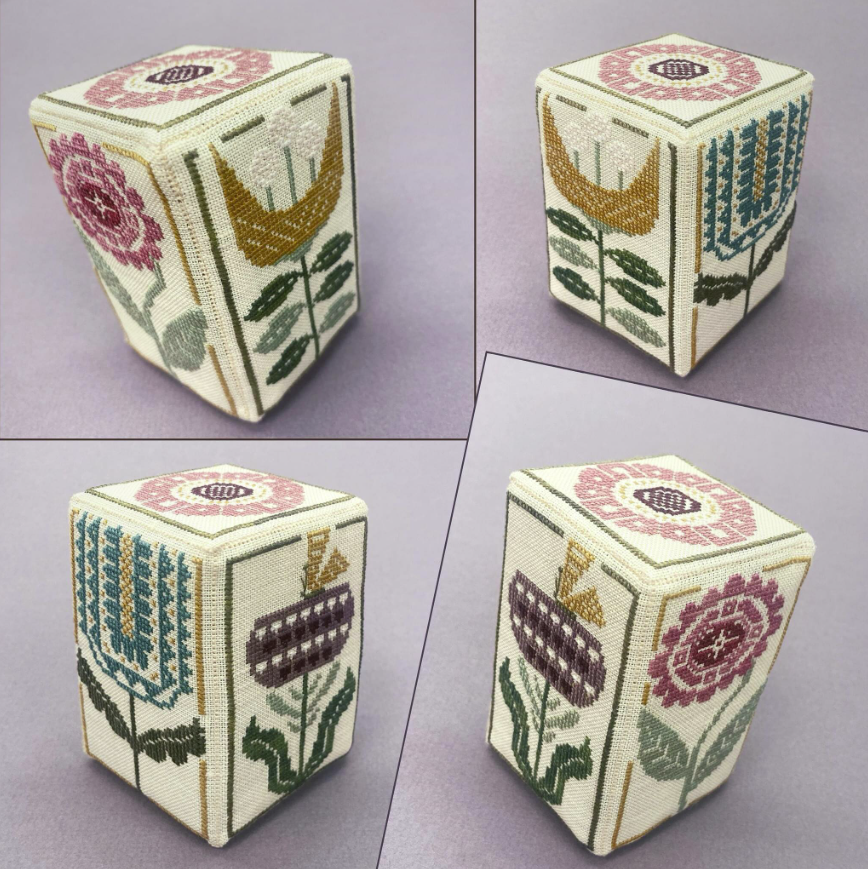 Embroidered cream cube with colorful floral and wheat-like patterns, shown from four angles on a light background