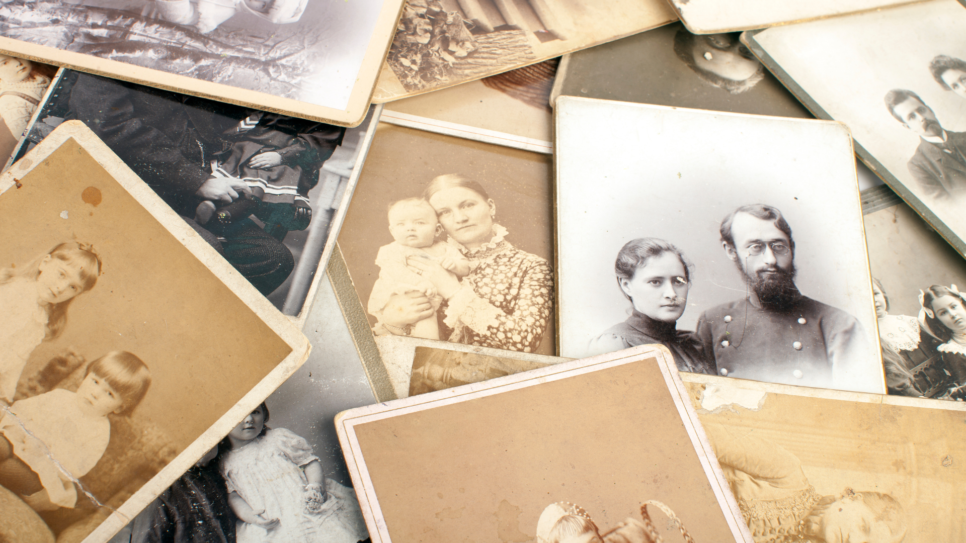 A pile of old black and white photos of people and animals.