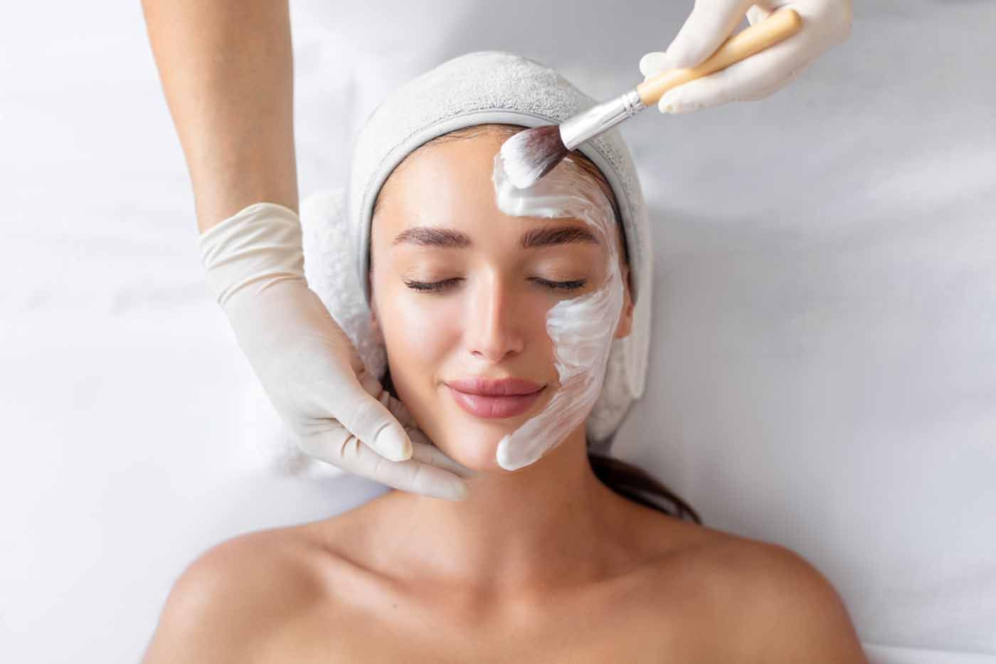 A woman is getting a facial treatment at a spa.
