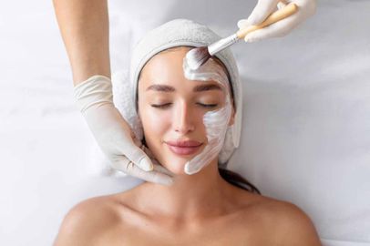 A woman is getting a facial treatment at a spa.