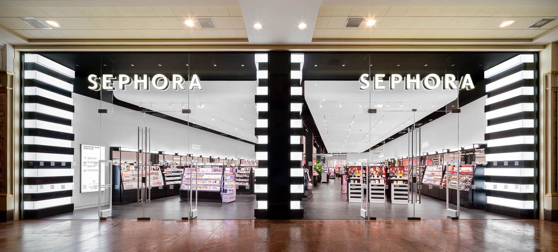 Sephora storefront with bright black-and-white striped entrance and cosmetics displays inside
