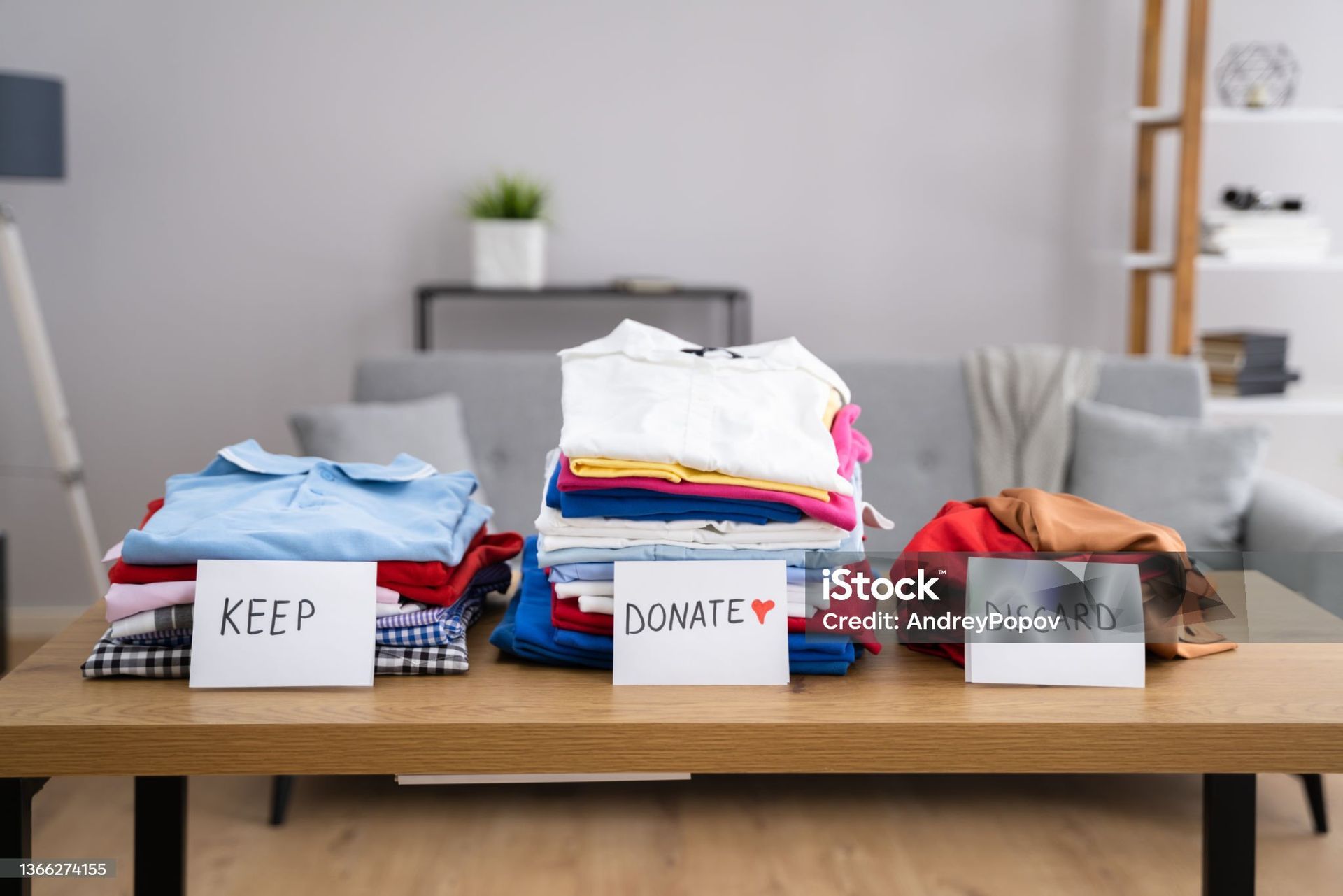 piles of closes to keep and toss