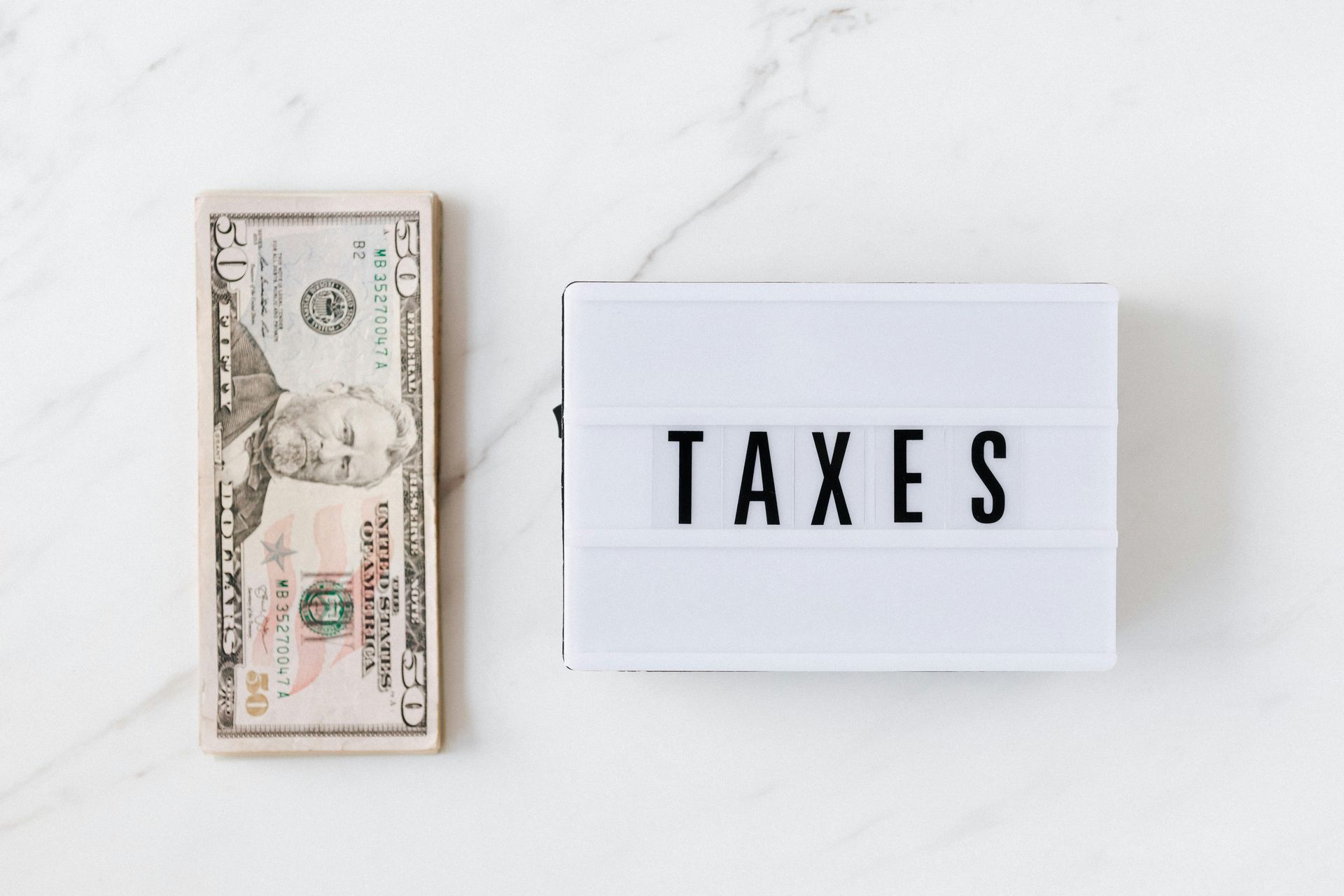 Picture of money and taxes on table