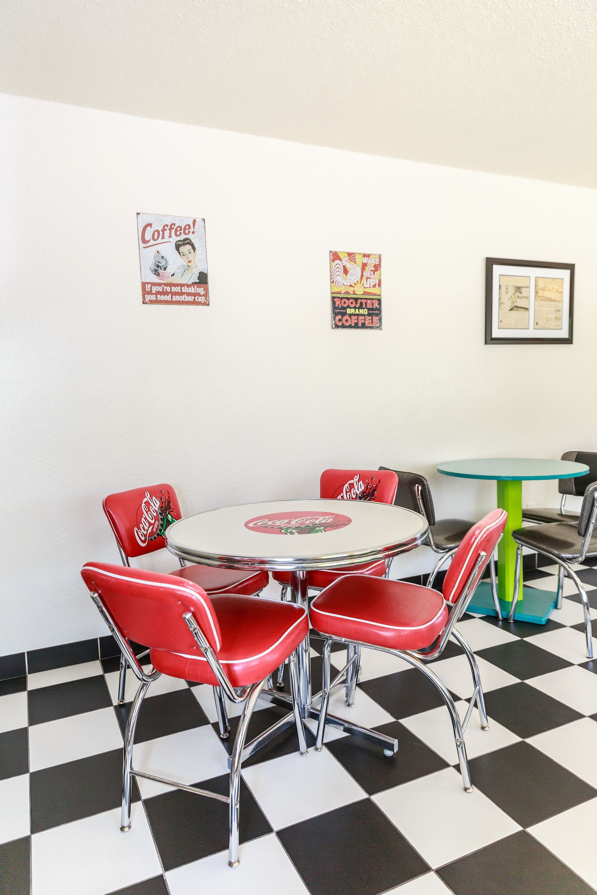 Dining area in the breakfast room with vintage posters on the wall.