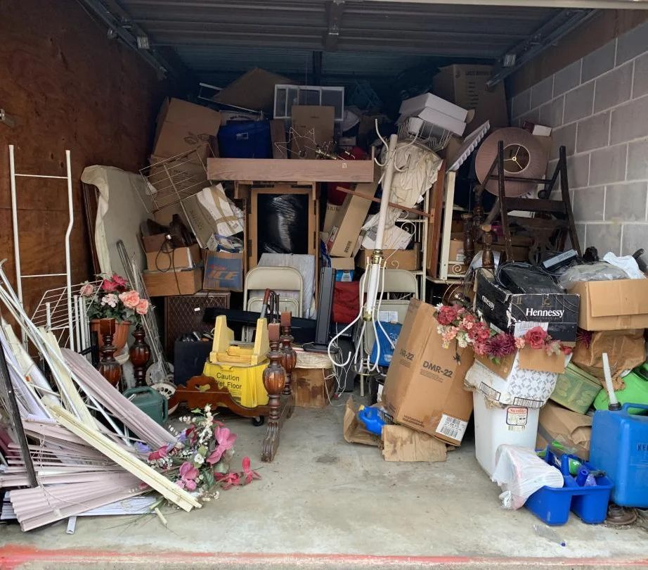 A garage filled with lots of junk and boxes.