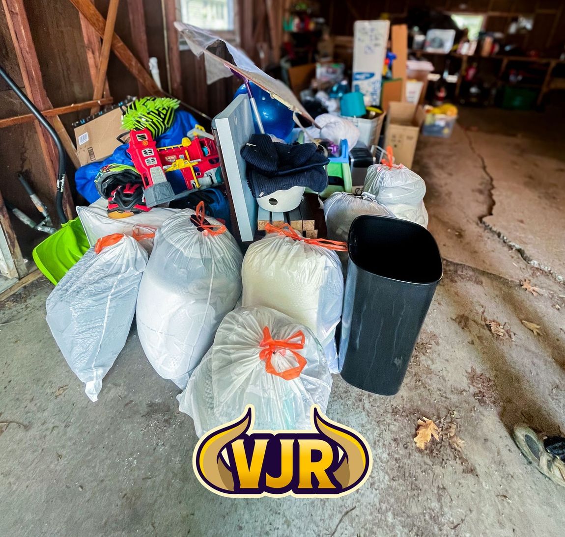 A pile of garbage in a garage with a vjr logo