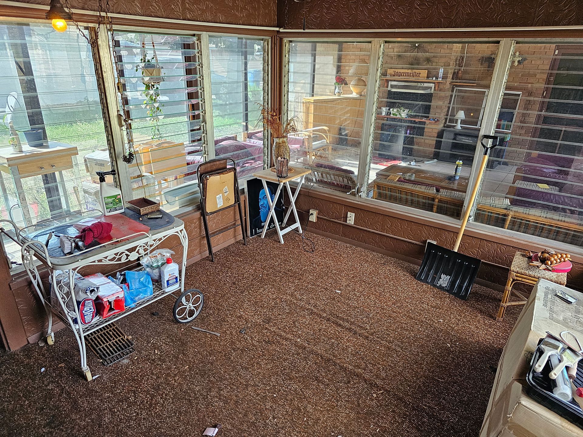 A room with a lot of windows and a carpeted floor.