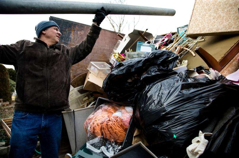 A garage filled with lots of junk and boxes.