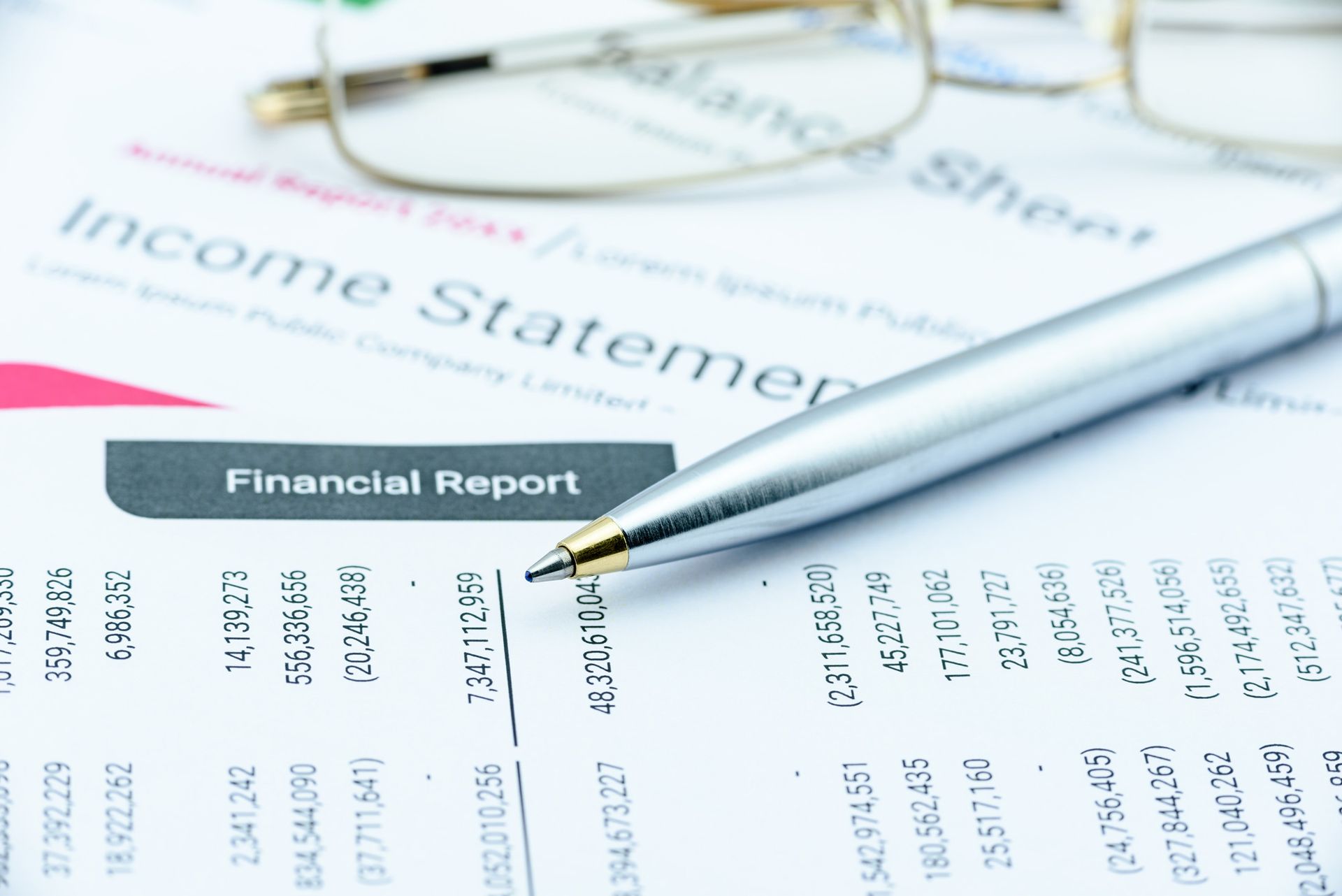 A pen is sitting on top of a financial report