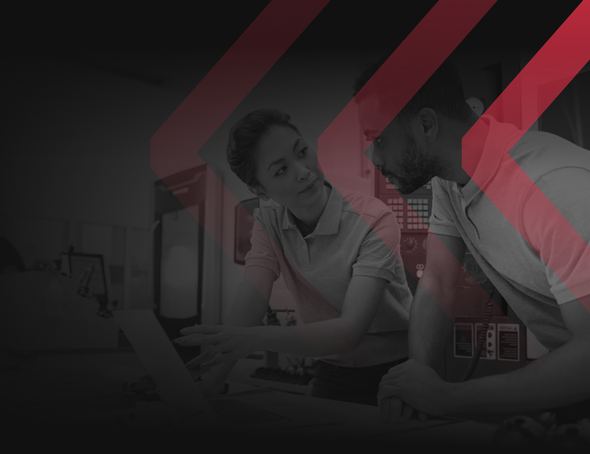 Two colleagues in a workspace looking at a laptop screen, overlaid with stylized red chevron patterns.