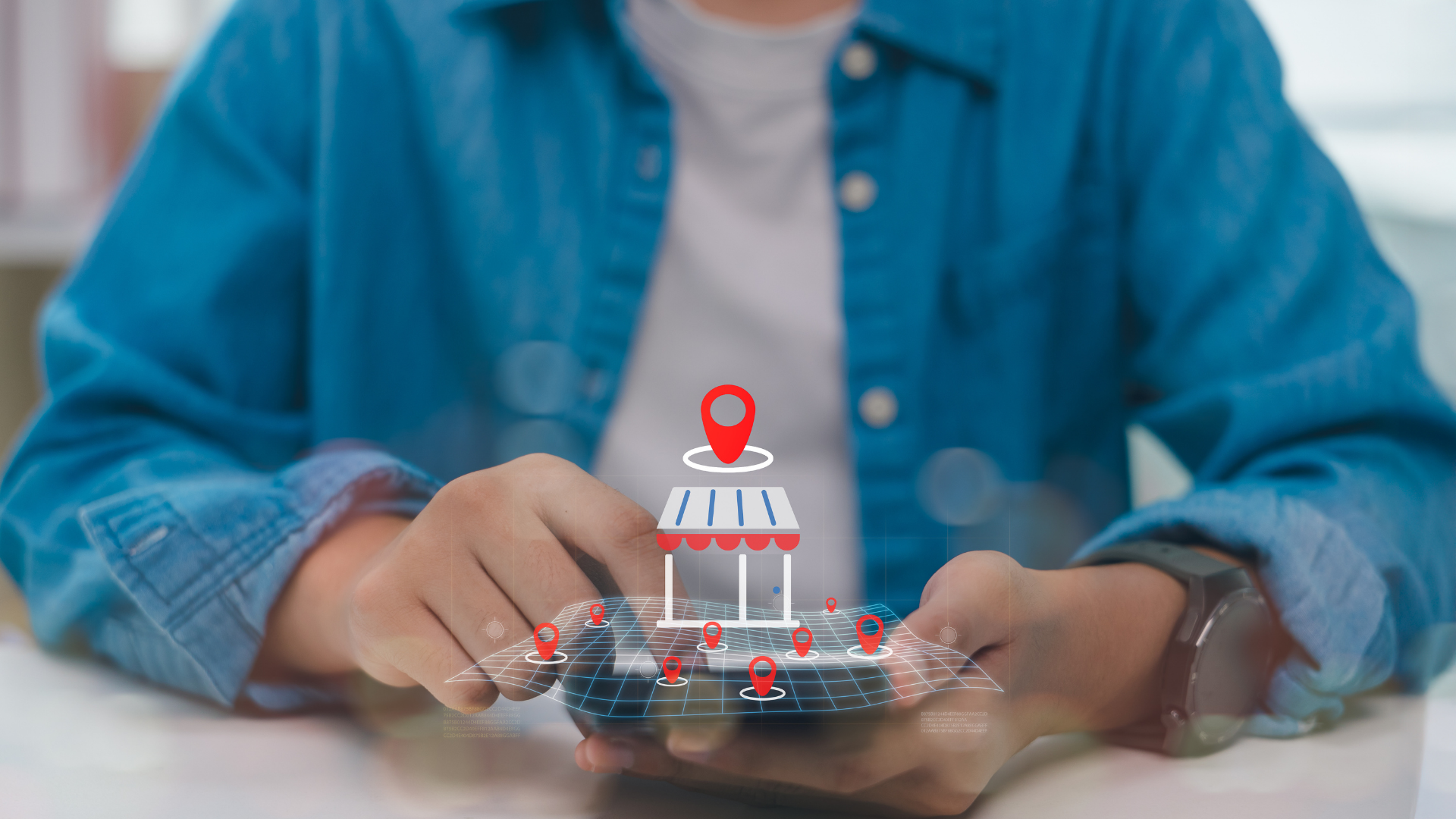 Hands holding a miniature house with a red location pin on a tabletop, symbolizing home search or real estate