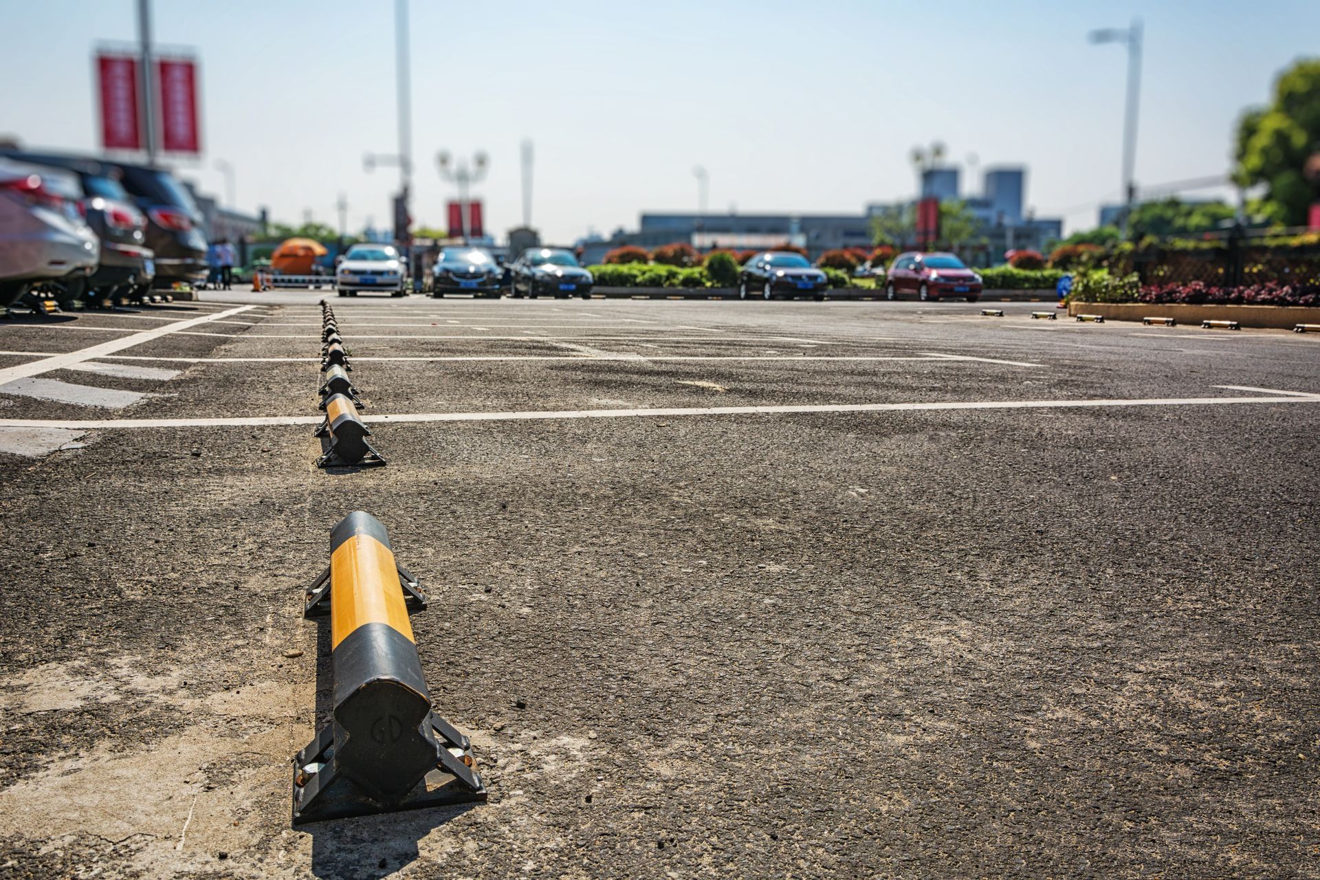Empty parking lot with painted speed bumps under bright daylight