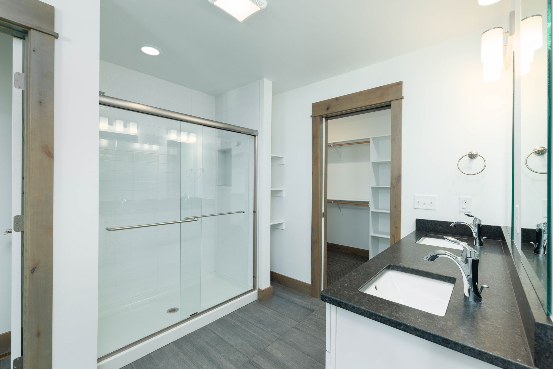 A bathroom with a sink and a walk in closet