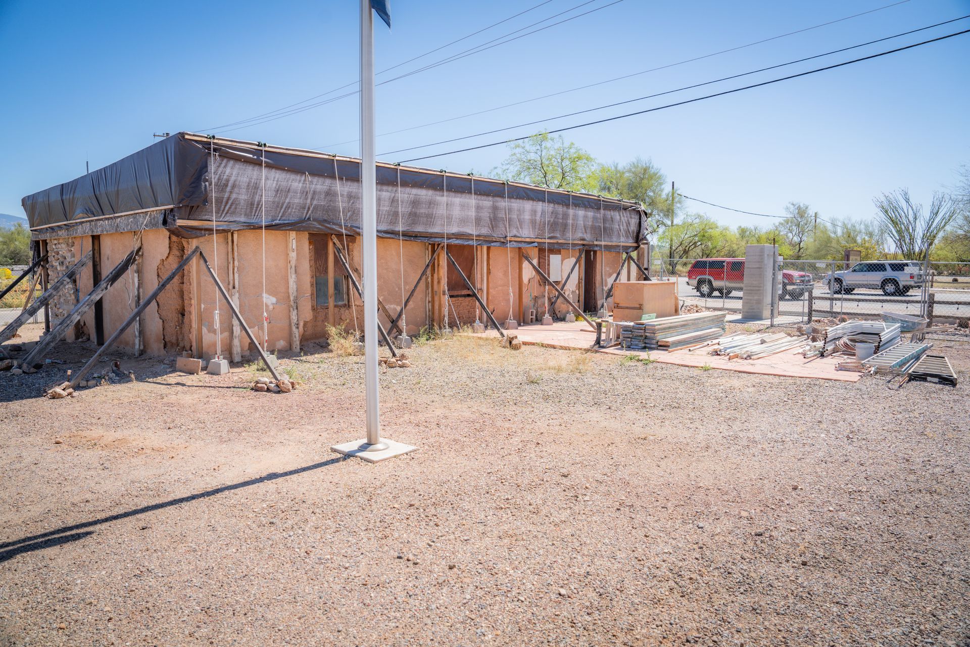 A building is being built in the middle of a dirt field.