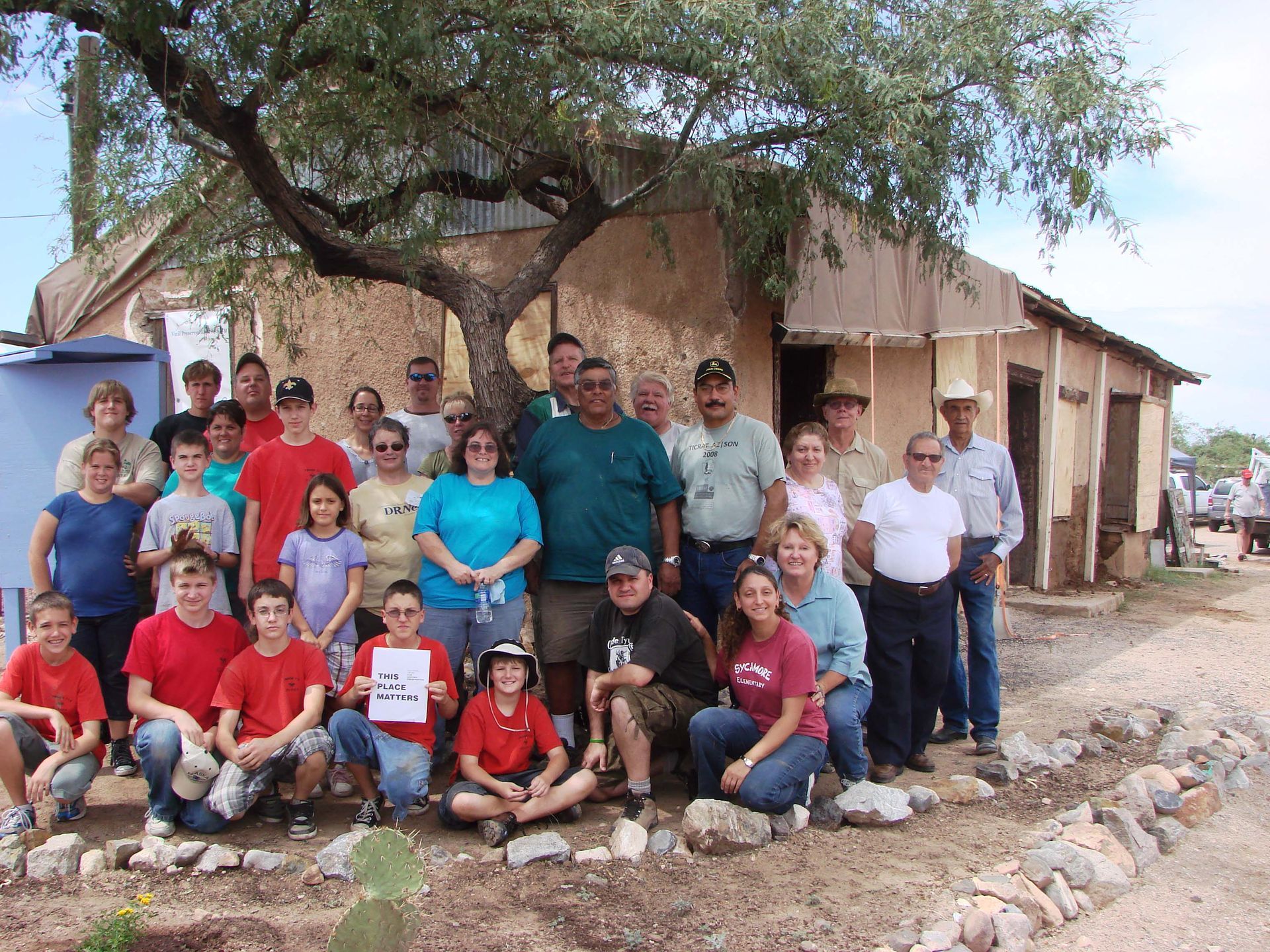 A group of people posing for a picture in front of a building