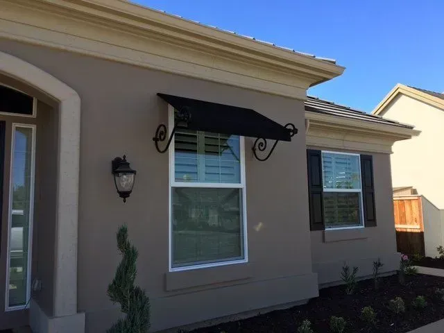A house with a black awning over a window
