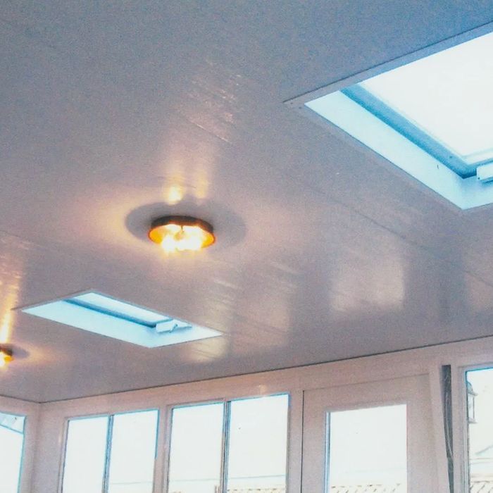 A room with a ceiling that has two skylights on it A room with a ceiling that has two skylights on it