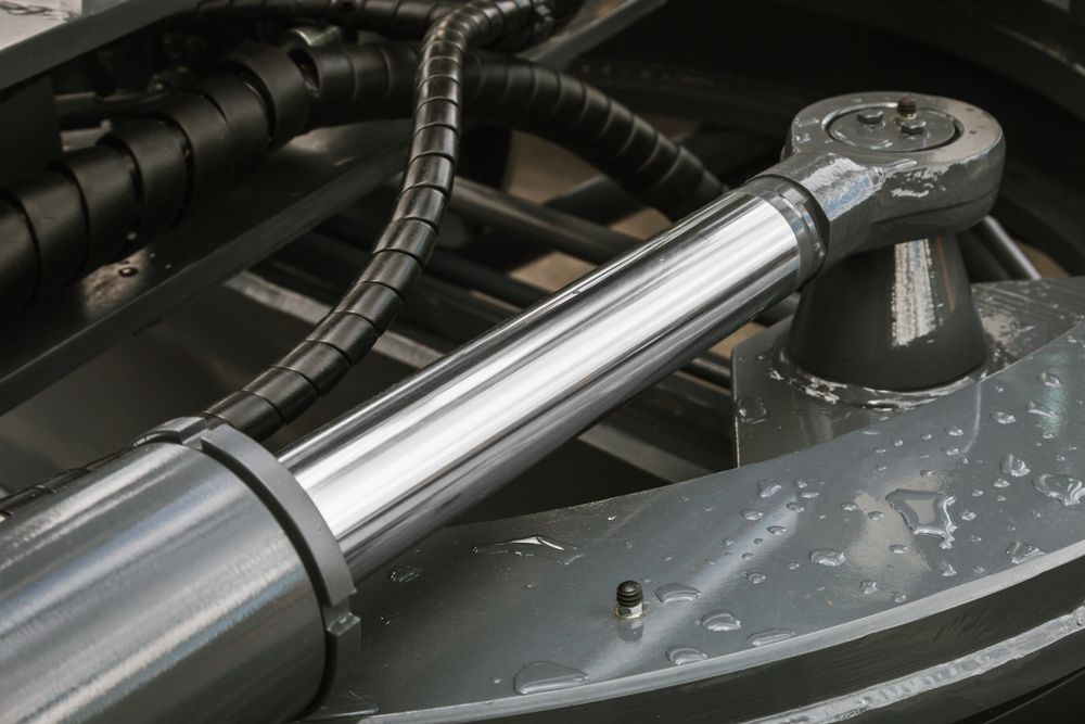 A Close Up Of A Hydraulic Cylinder With A Hose Attached To It — Gillies Enterprises Pty Ltd In Moree, NSW