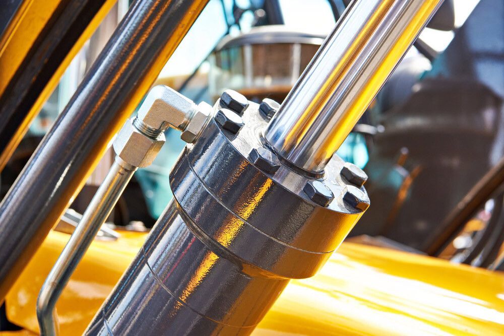 A Close Up of a Hydraulic Cylinder on a Yellow Vehicle — Gillies Enterprises Pty Ltd in Narrabri, NSW