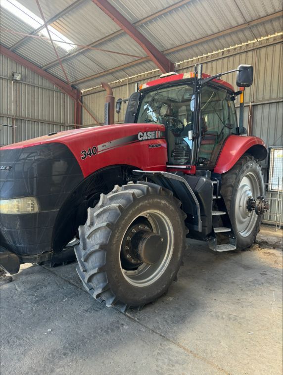 A Red Case Tractor Is Parked In A Warehouse — Gillies Enterprises Pty Ltd In Coonamble, NSW