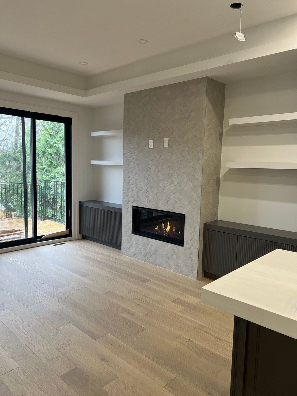 A living room with a fireplace and sliding glass doors.