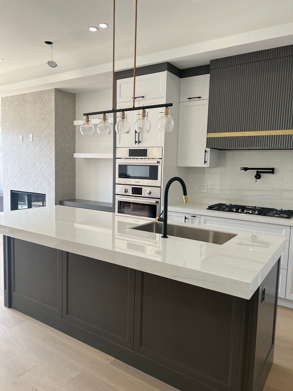 A kitchen with a large island and a sink