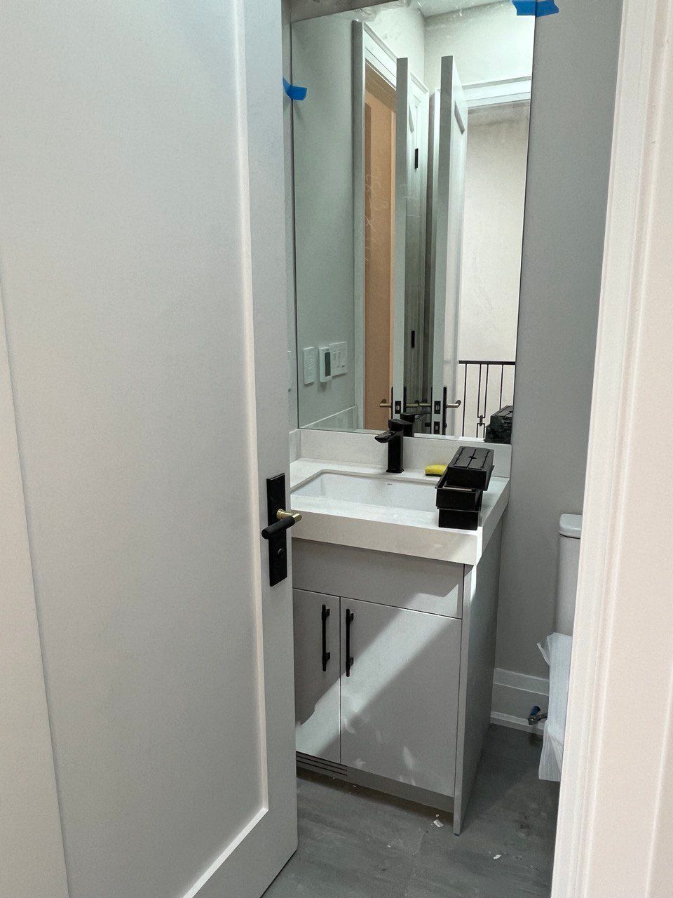 A bathroom with a sink , mirror and toilet.