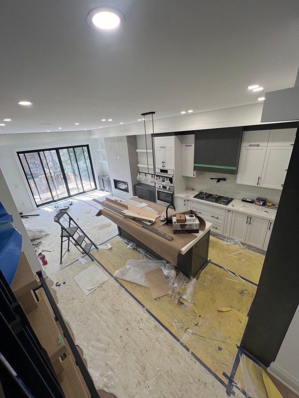 A kitchen under construction with a large island in the middle of the room.