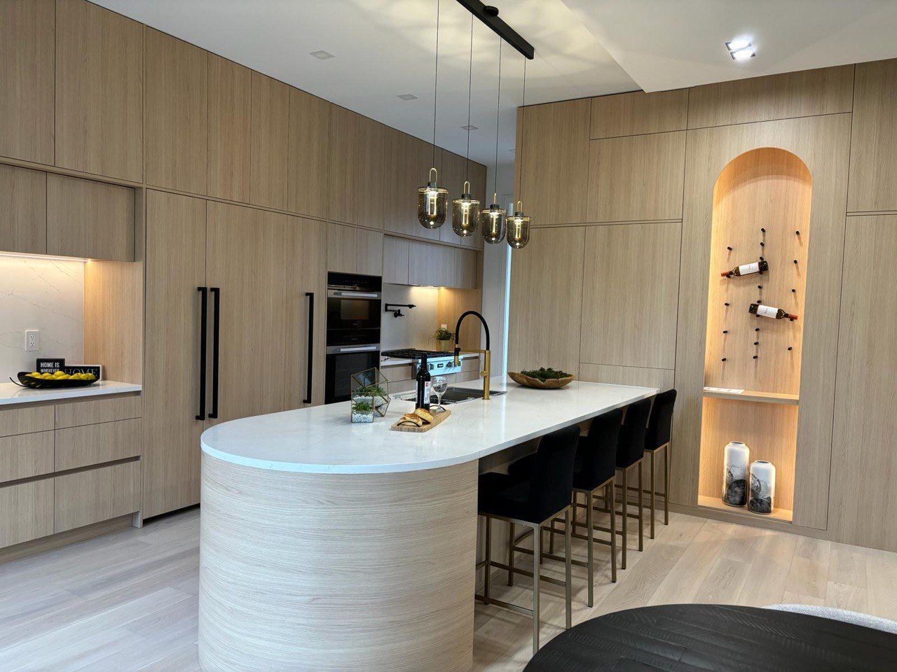 A kitchen with a large island and stools