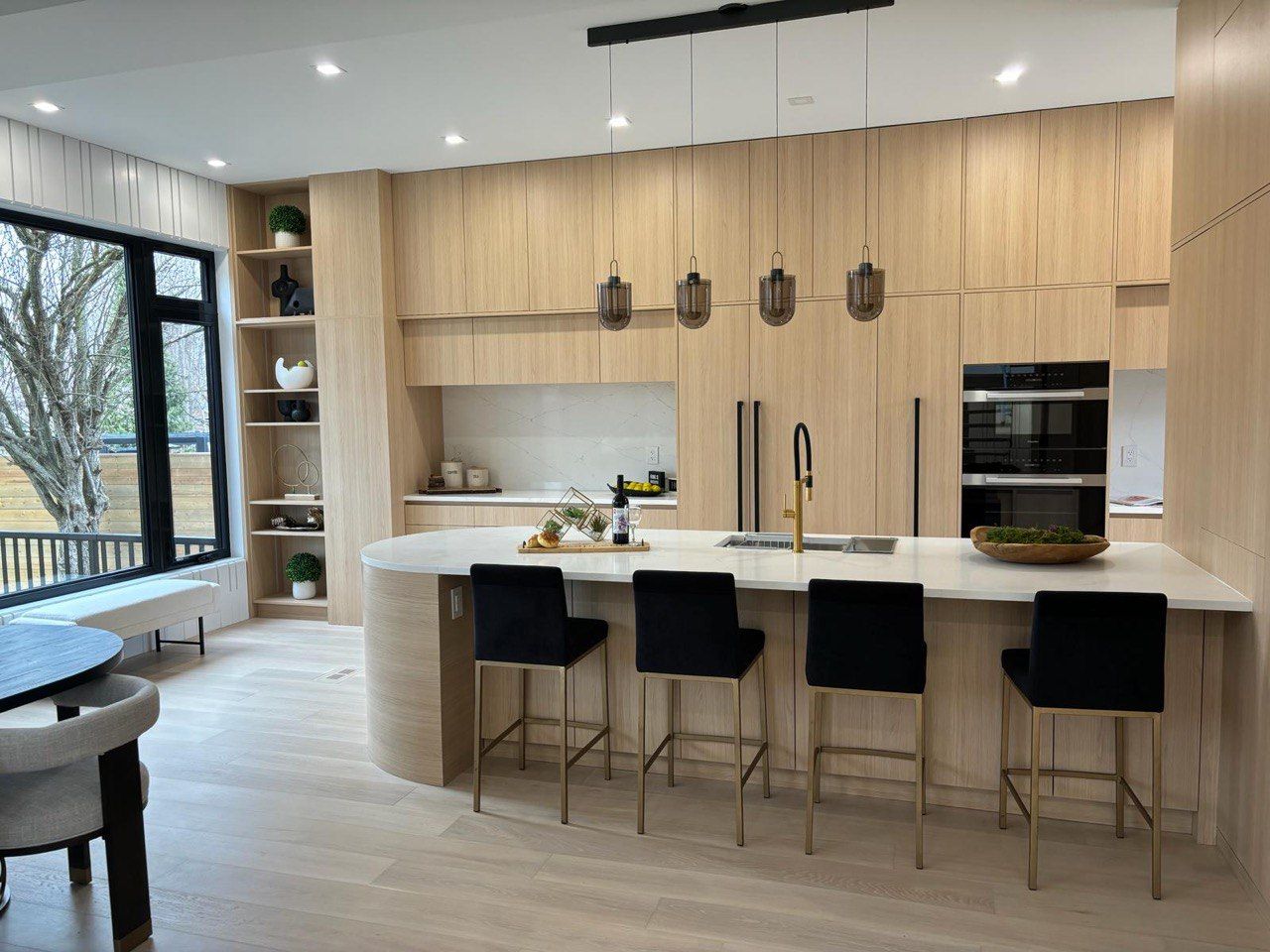 A kitchen with wooden cabinets and a large island in the middle of the room.