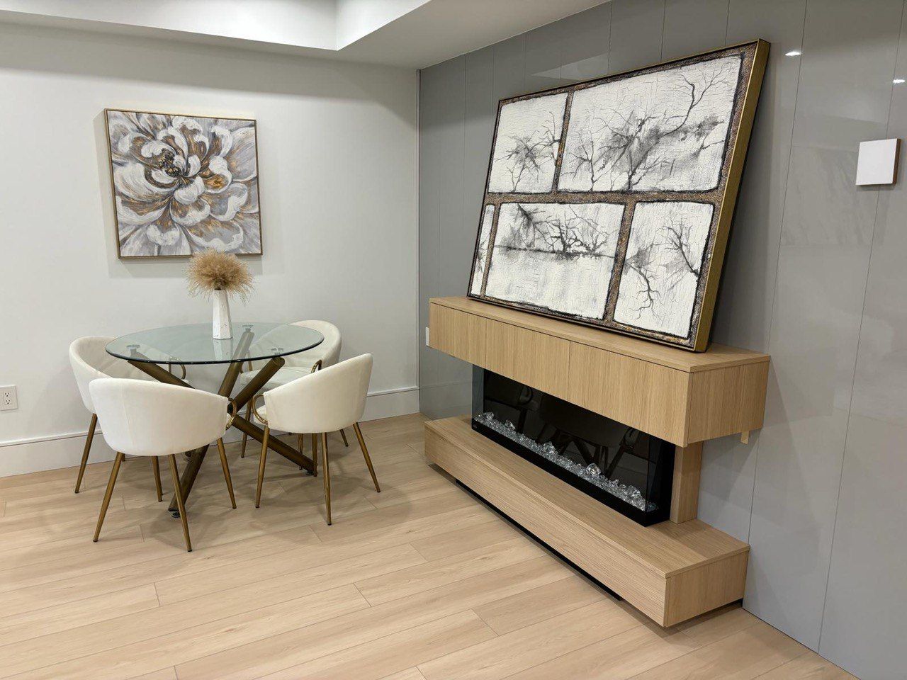 A dining room with a table and chairs and a fireplace.