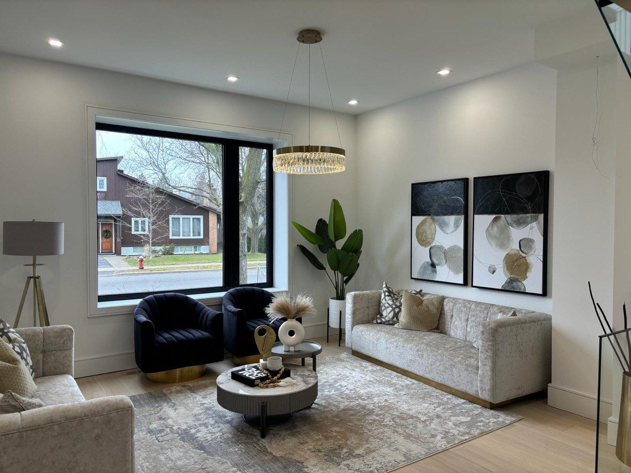 A living room filled with furniture and a large window.