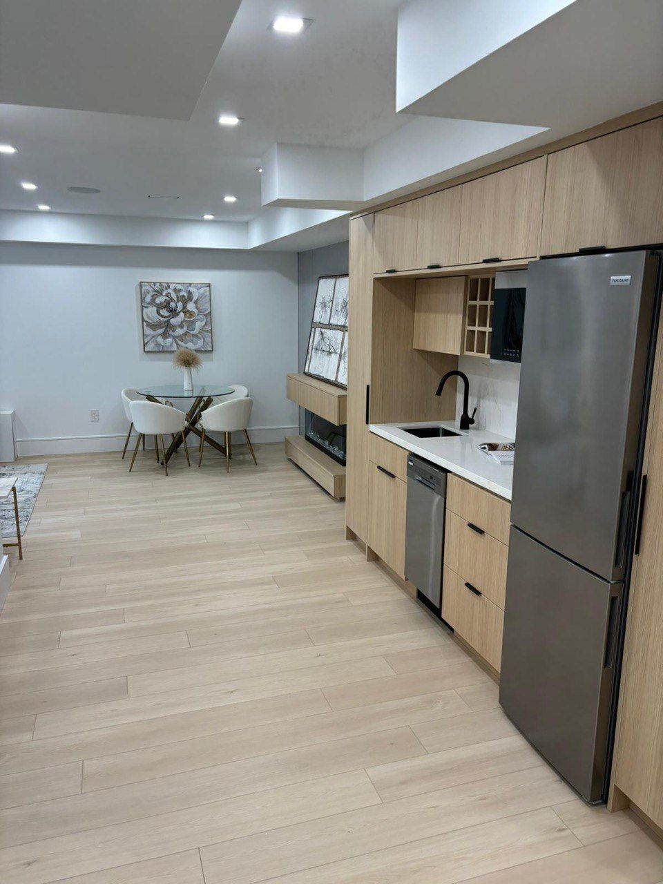 A kitchen with stainless steel appliances and wooden cabinets