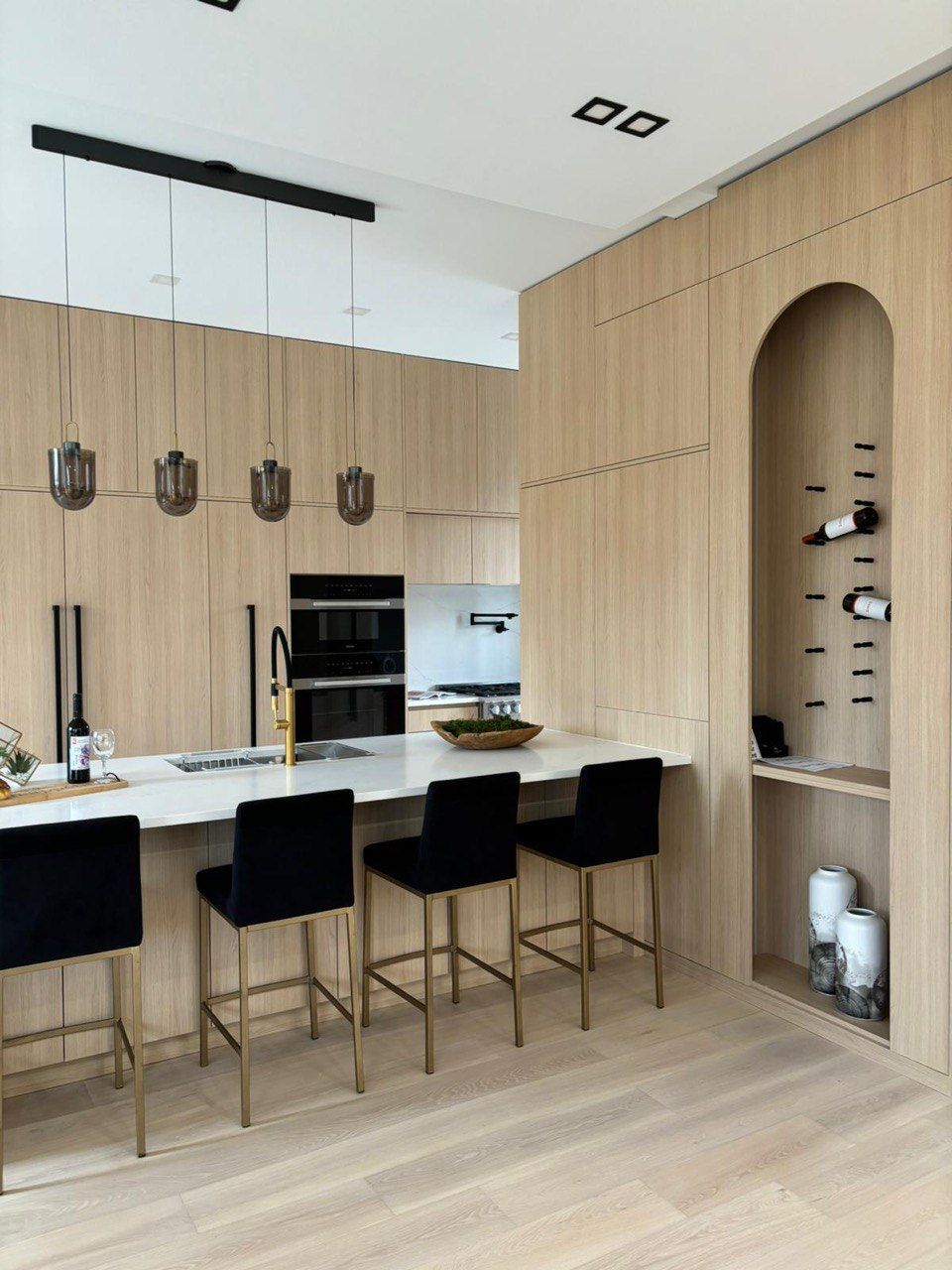 A kitchen with wooden cabinets and a wine rack