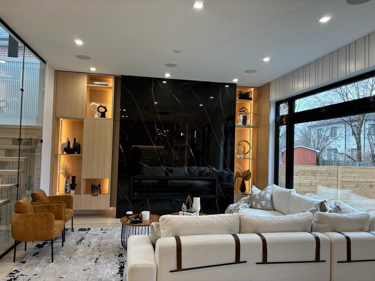 A living room with a couch , chairs , and a fireplace.