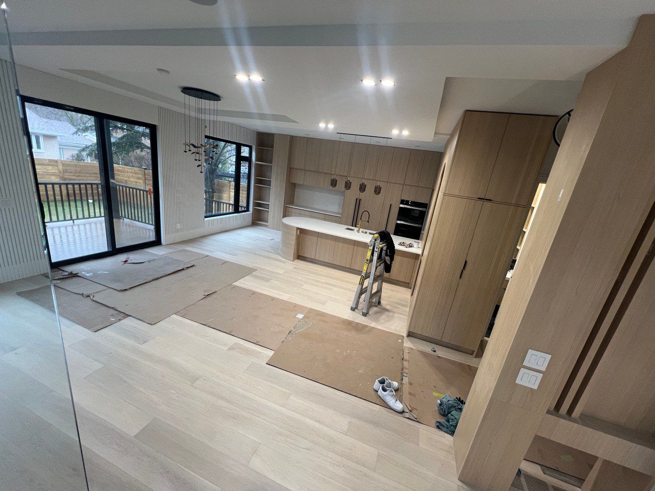 There is a ladder in the middle of the room in the kitchen.
