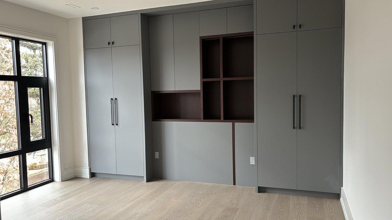 A large room with a lot of cabinets and a window.