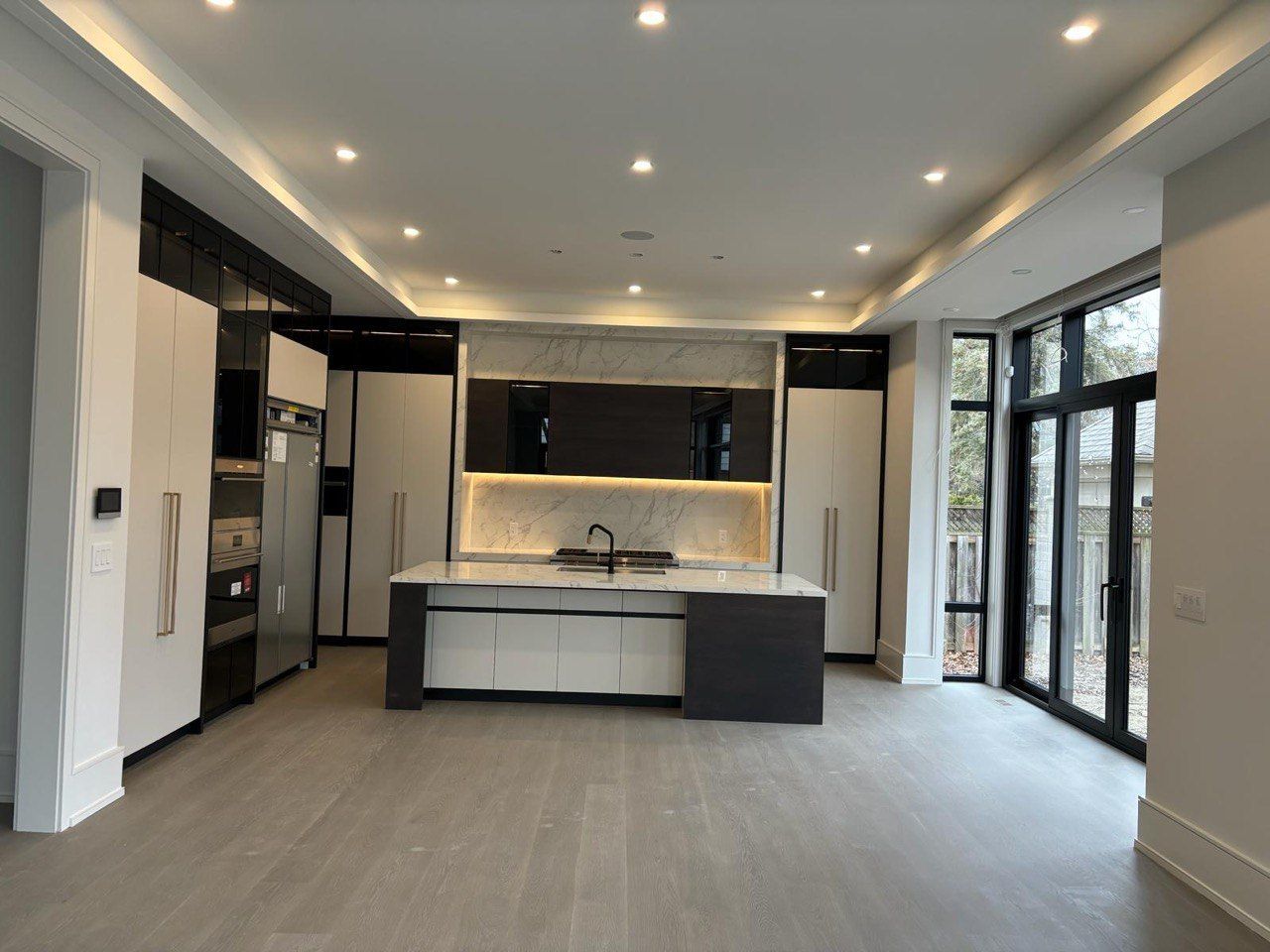 An empty kitchen with a large island in the middle