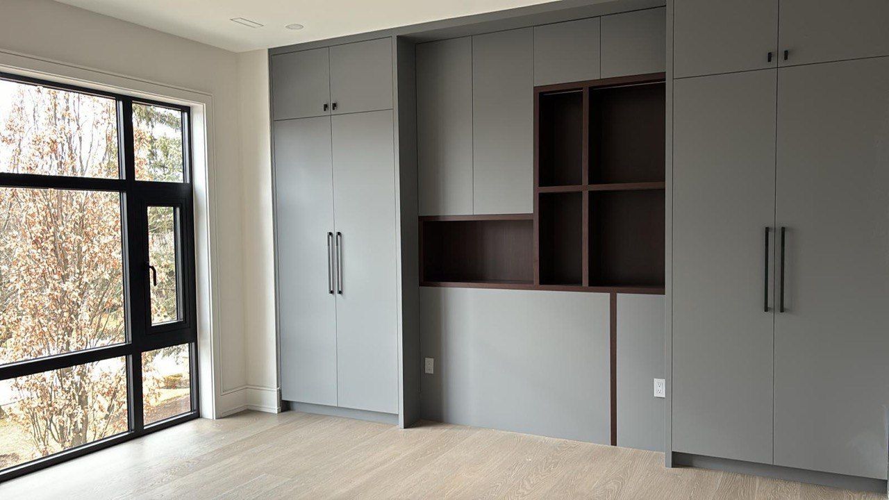 A room with a lot of cabinets and a large window.