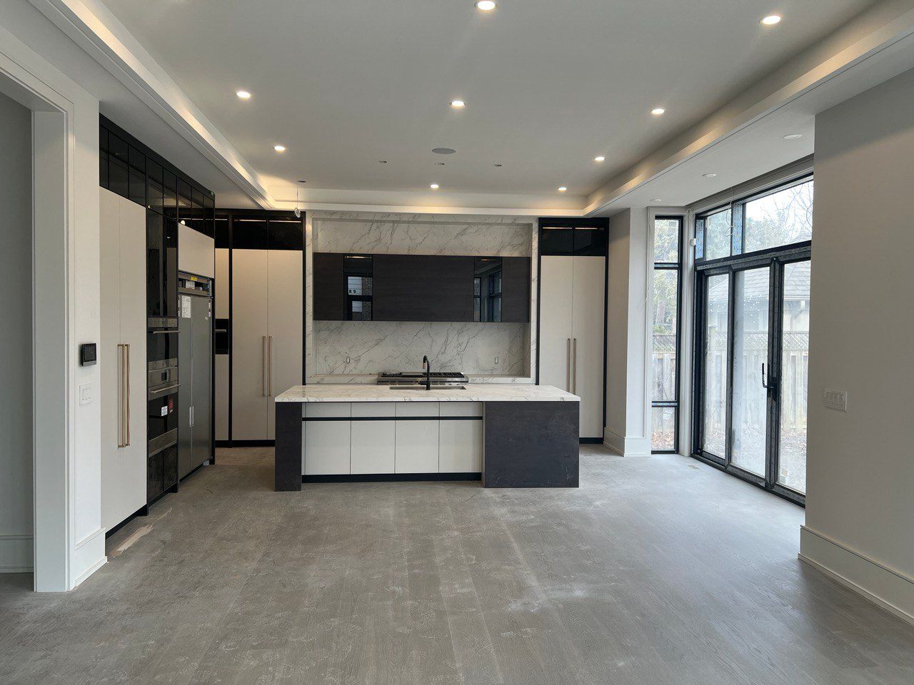 An empty kitchen with a large island in the middle