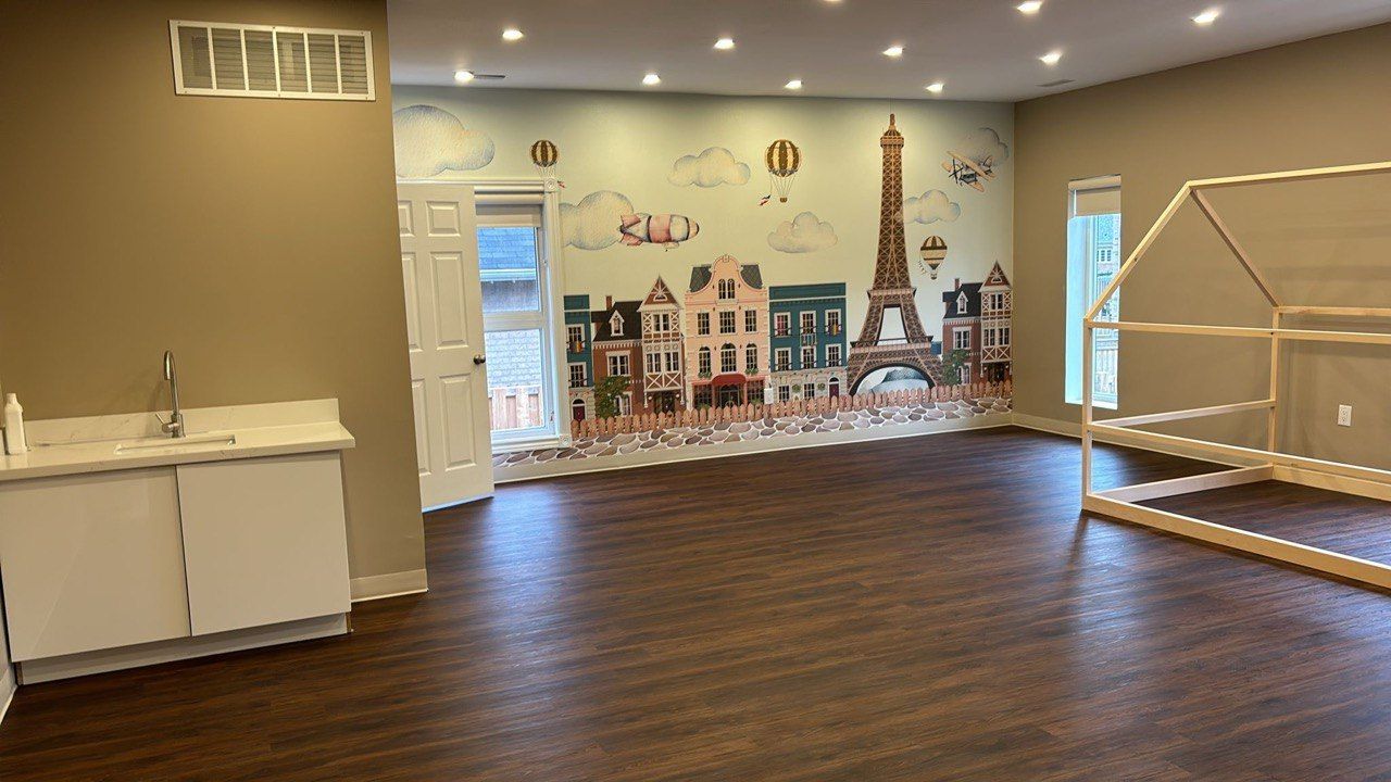 An empty room with a mural of a city on the wall.